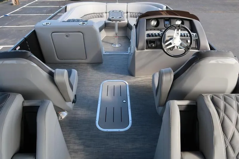 Slide: The Image of 2021 Bennington R Bowrider Quad Bench 24 RTFB interior with luxurious seating and modern dashboard. - 27