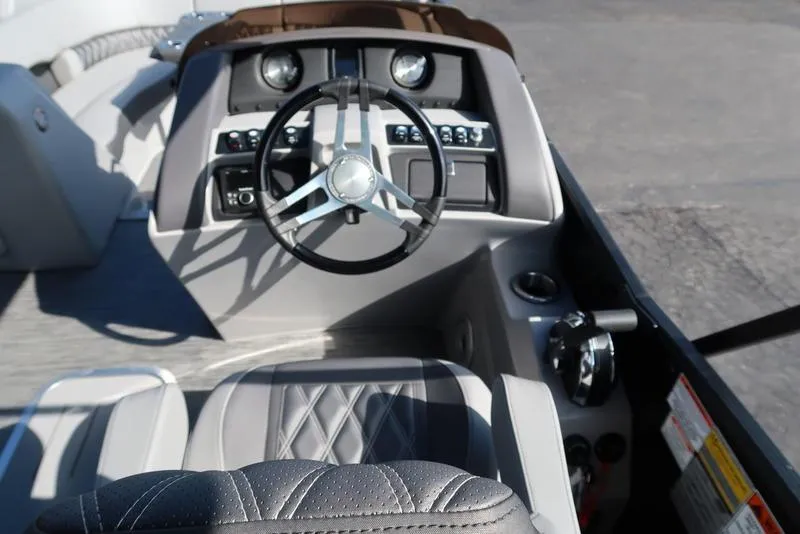 Slide: The Image of 2021 Bennington R Bowrider Quad Bench 24 RTFB helm with modern steering and controls. - 30