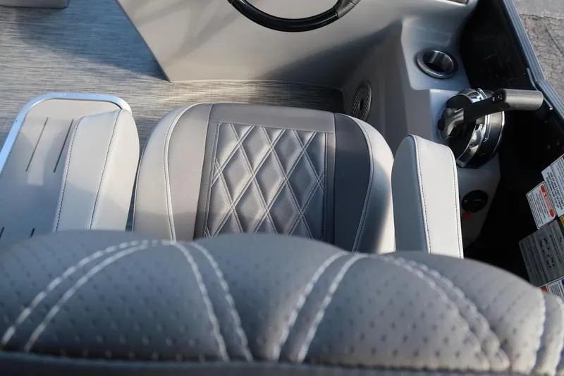 Slide: The Image of 2021 Bennington R Bowrider Quad Bench 24 RTFB interior with luxurious seating and control panel. - 32