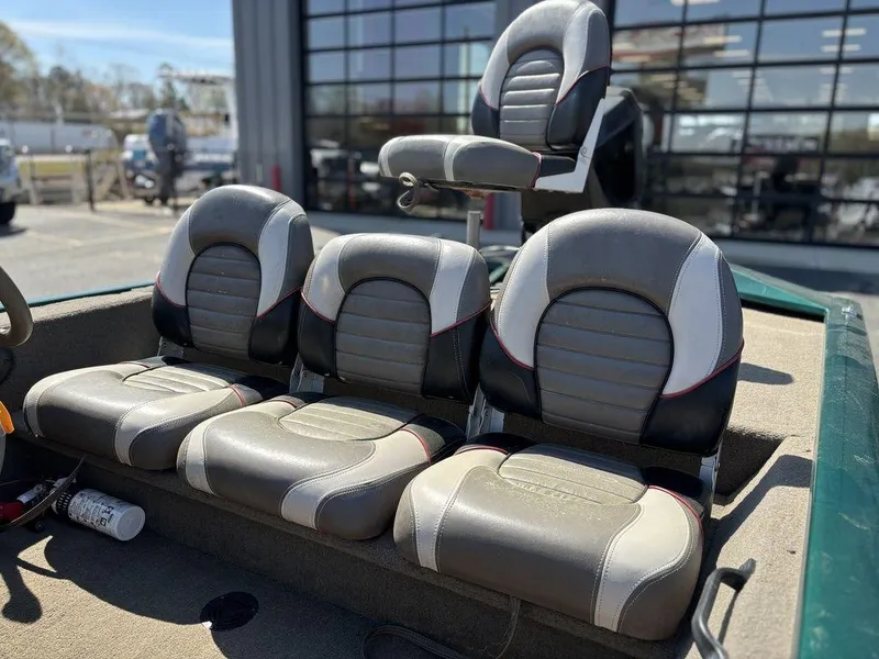 Slide: The Image of 2004 Tracker Pro Team 185 boat seats, gray and white, in outdoor setting. - 11