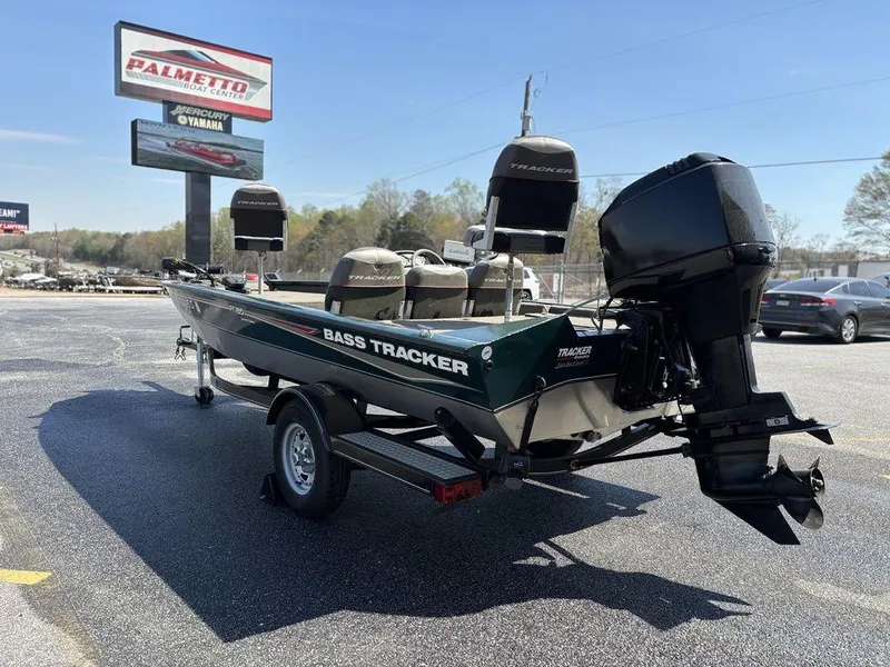 Slide: The Image of 2004 Tracker Pro Team 185 bass boat on trailer, displayed outdoors near dealership. - 5