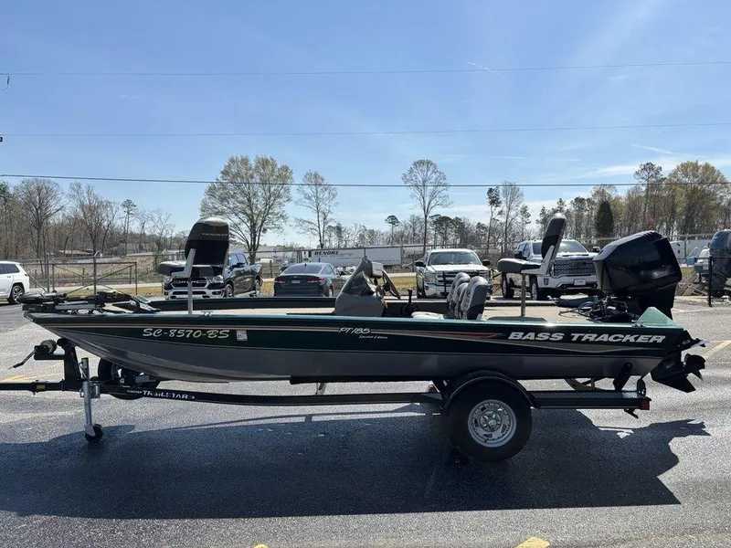 Slide: The Image of 2004 Tracker Pro Team 185 bass boat on trailer, parked outdoors under clear sky. - 7