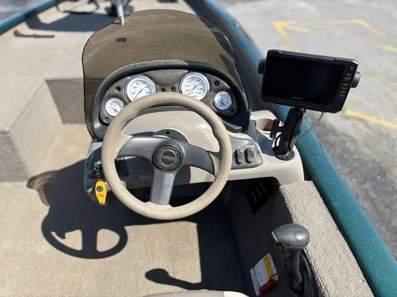 Slide: The Image of 2004 Tracker Pro Team 185 boat dashboard with steering wheel and navigation system. - 8