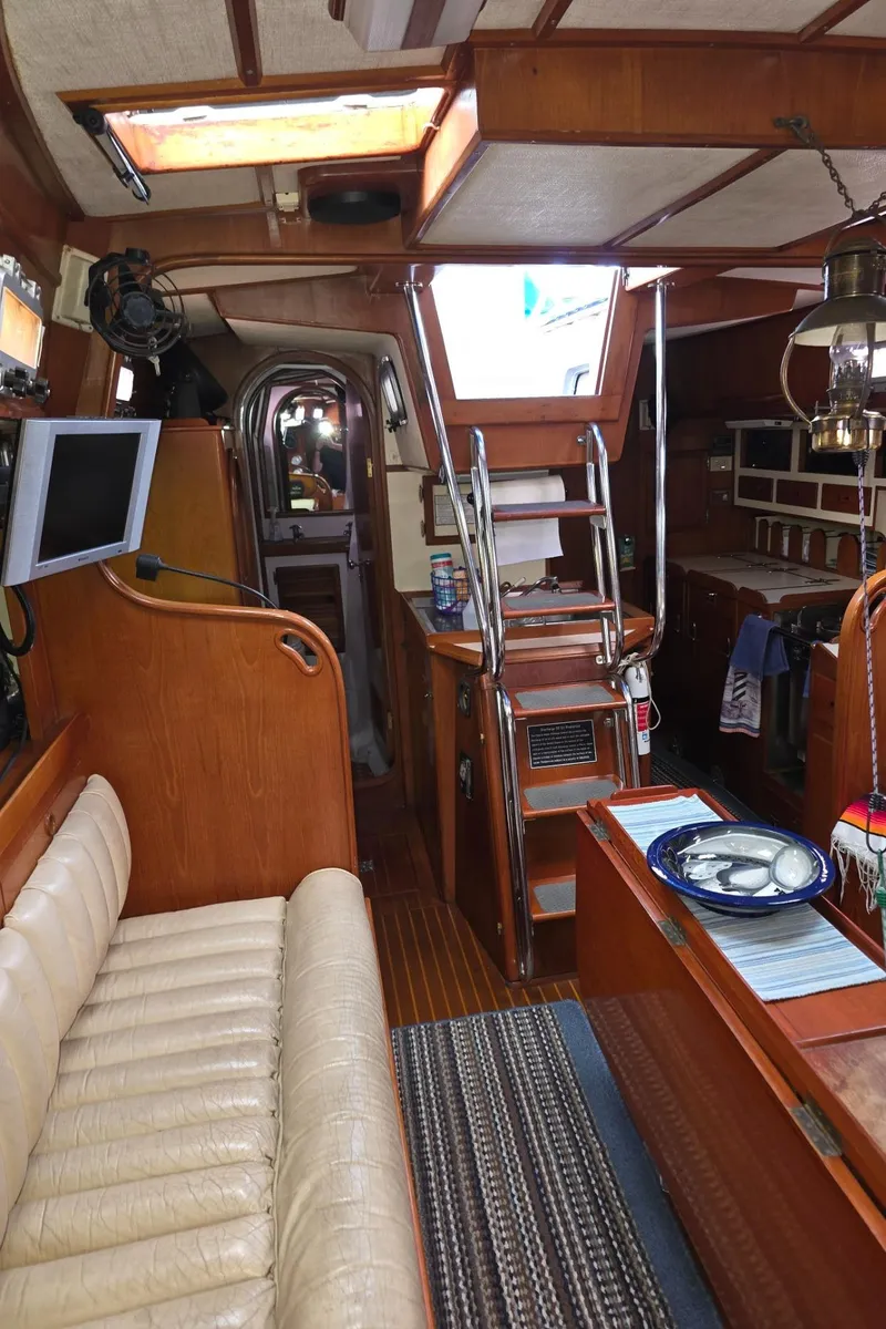 Slide: The Image of Interior of a 1982 Stevens 40" yacht with wooden furnishings and cozy seating. - 10