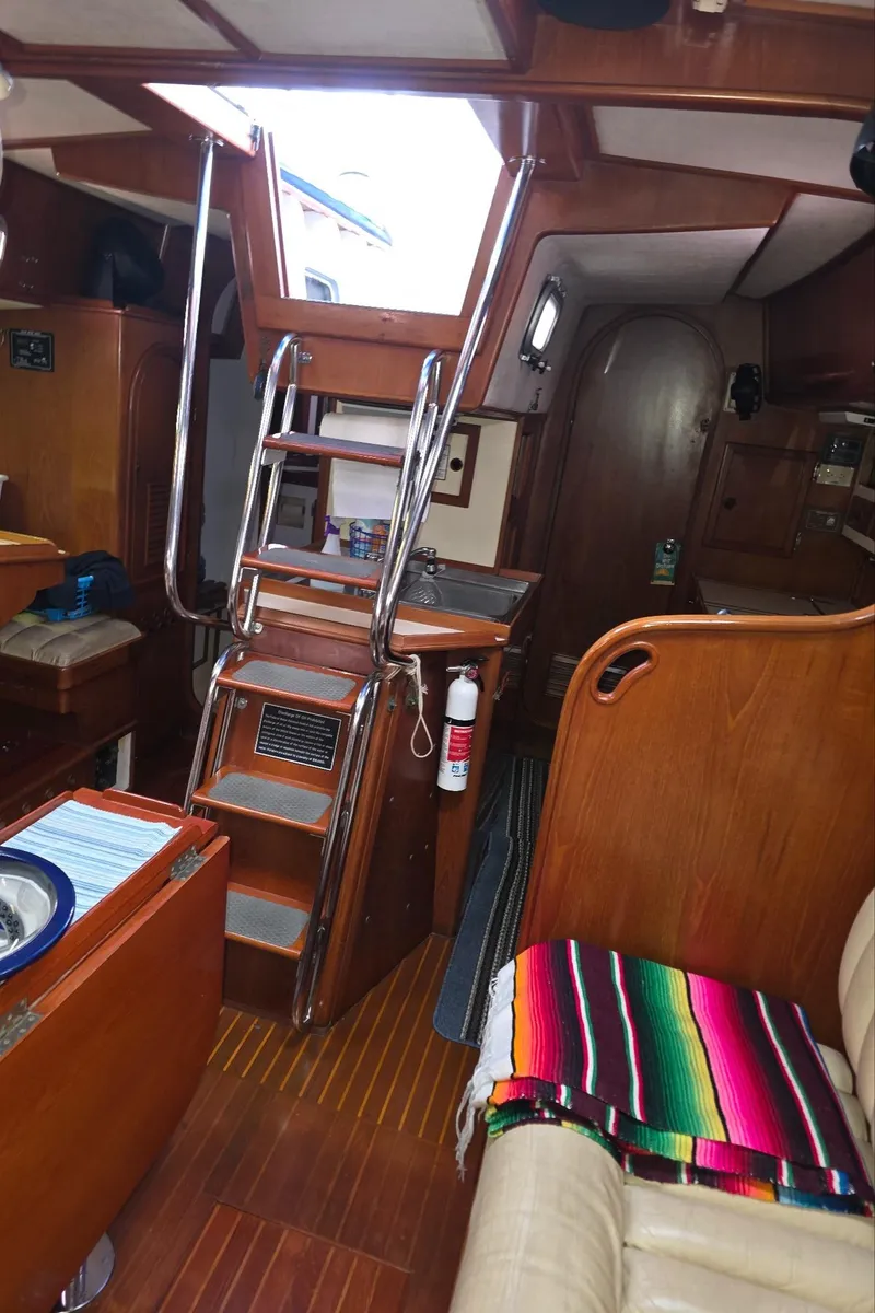 Slide: The Image of Interior of a 1982 Stevens 40" yacht with wooden finishes and colorful blanket. - 11