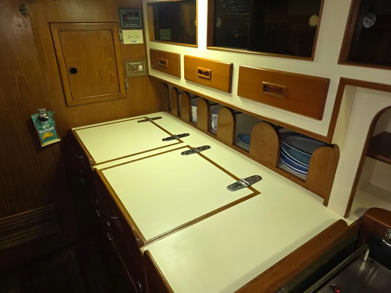 Slide: The Image of Vintage 1982 Stevens 40" yacht galley with wooden cabinets and countertop. - 13