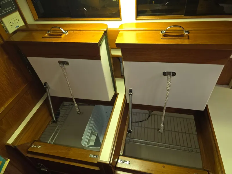 Slide: The Image of Wooden storage compartments on a 1982 Stevens 40" boat, open with visible interior. - 14