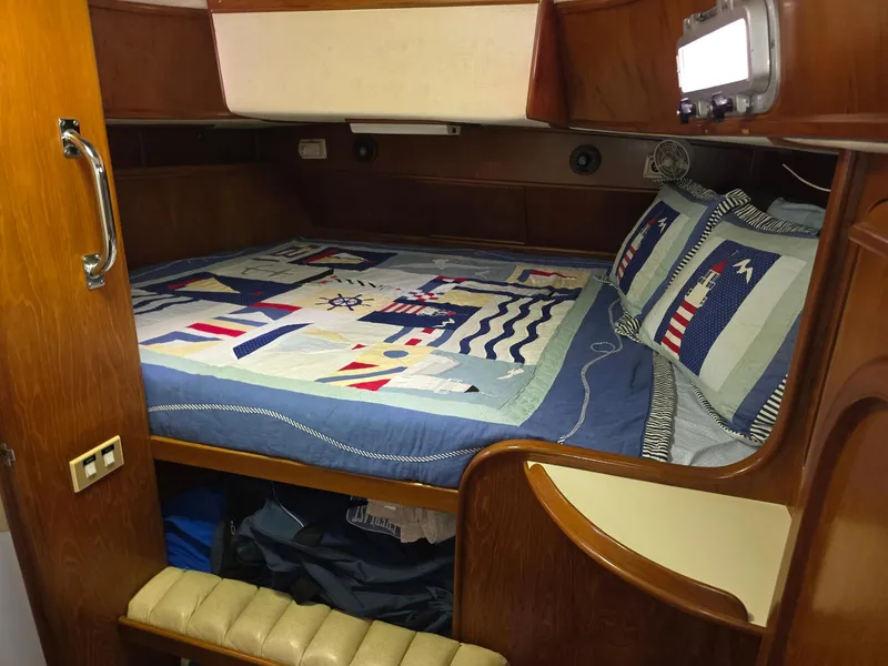 Slide: The Image of Cozy cabin interior of 1982 Stevens 40" yacht with nautical-themed bedding. - 18