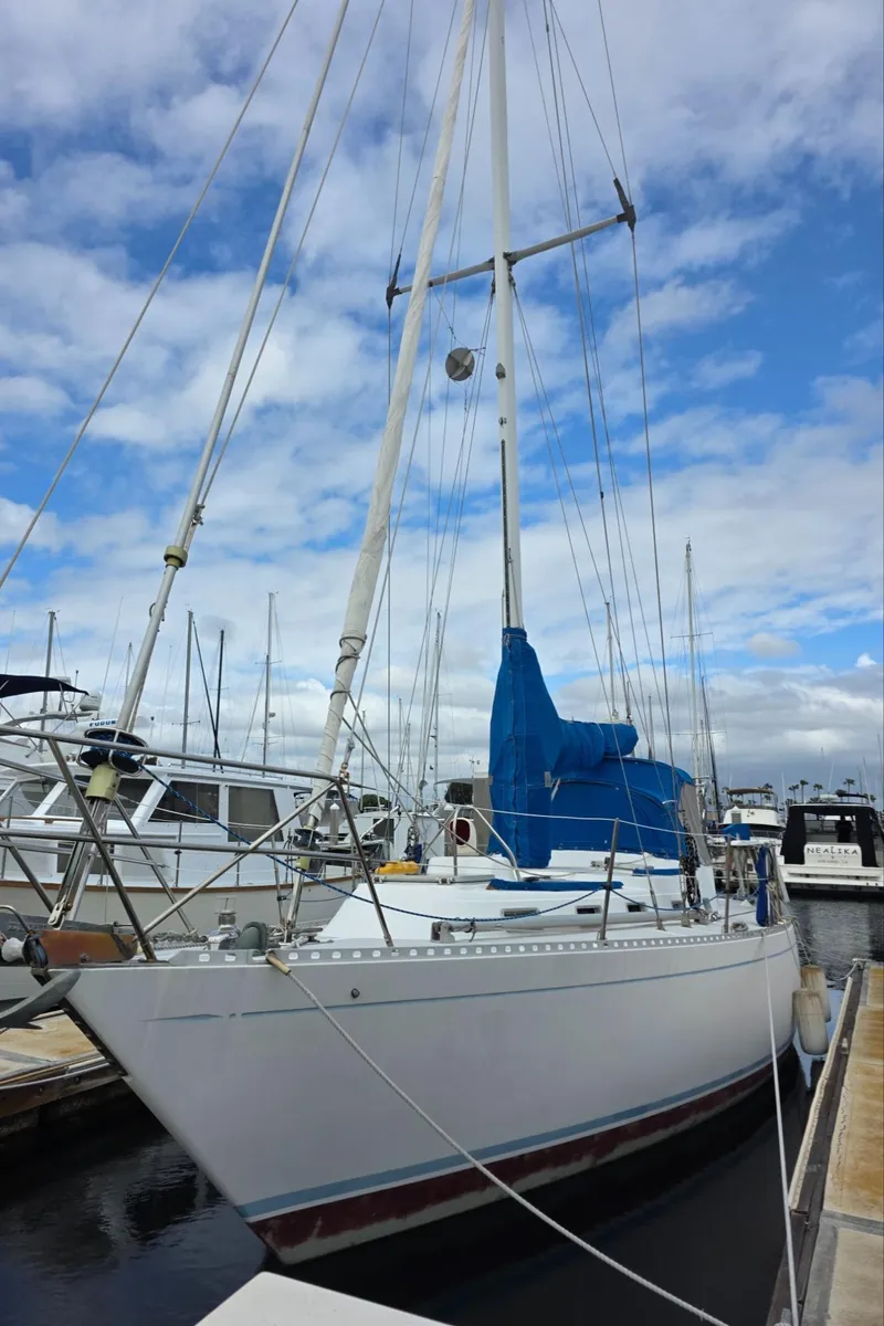 Slide: The Image of 1982 Stevens 40" sailboat docked at marina under cloudy sky. - 2