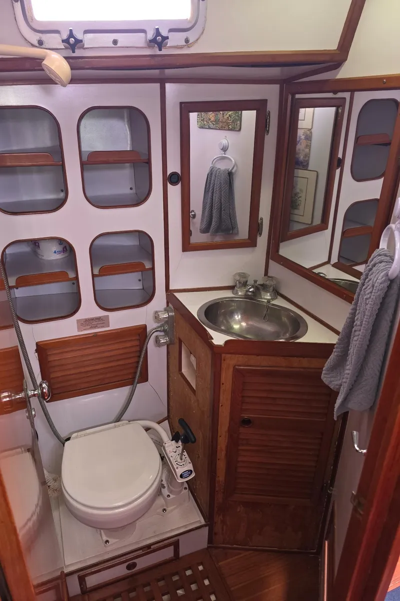 Slide: The Image of 1982 Stevens 40" yacht bathroom with wooden accents, sink, and toilet. - 20