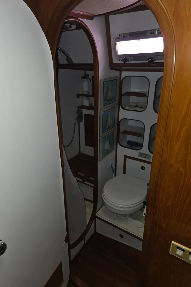 Slide: The Image of 1982 Stevens 40" yacht bathroom with wooden accents and compact design. - 28