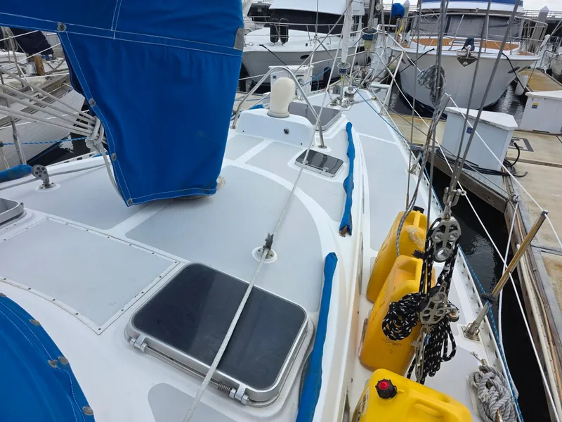 Slide: The Image of 1982 Stevens 40" sailboat deck with blue covers and yellow fuel containers at marina. - 31