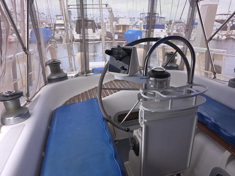 Slide: The Image of Stevens 40" sailboat cockpit, 1982 model, featuring steering wheel and marina view. - 32