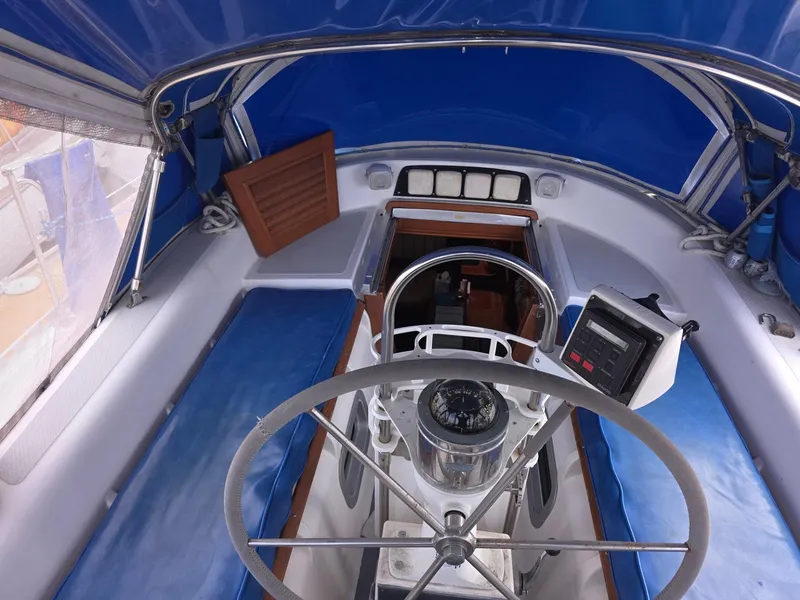 Slide: The Image of 1982 Stevens 40" sailboat cockpit with blue canopy and steering wheel. - 33