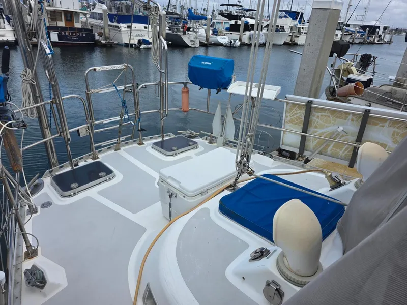 Slide: The Image of 1982 Stevens 40" sailboat deck at marina, featuring hatches and equipment, with boats in background. - 34