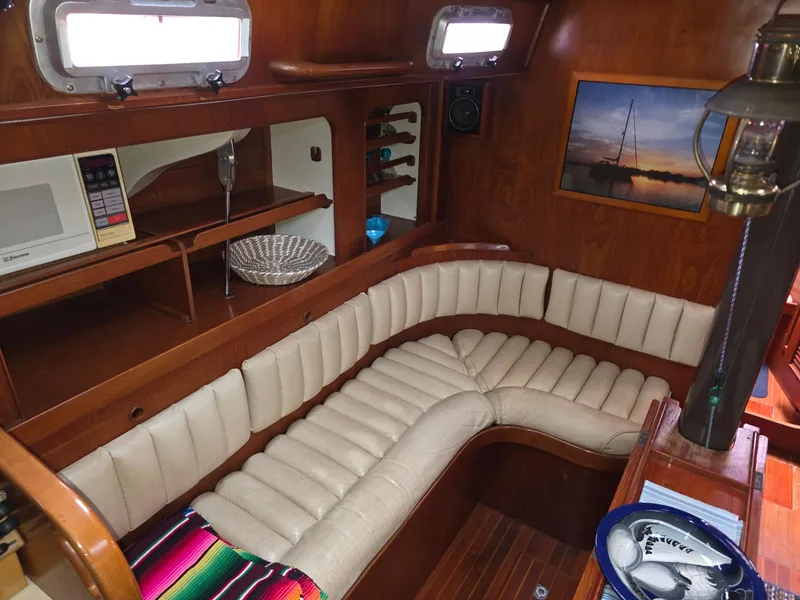 Slide: The Image of Interior of a 1982 Stevens 40" yacht with a cozy, curved seating area. - 5