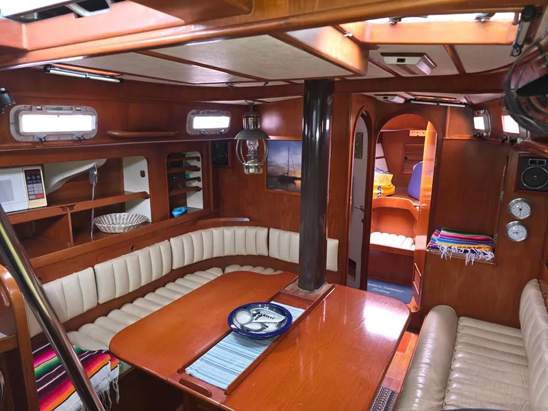 Slide: The Image of Luxurious 1982 Stevens 40" yacht interior with wood finish and cozy seating area. - 7