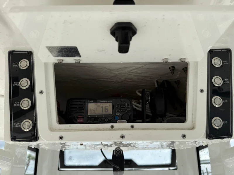 Slide: The Image of 2022 Tidewater 232 CC Adventure boat console with radio and control buttons. - 10