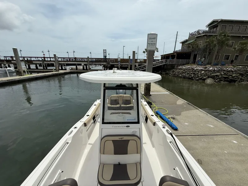 Slide: The Image of 2022 Tidewater 232 CC Adventure boat docked at a marina, view from the bow. - 17