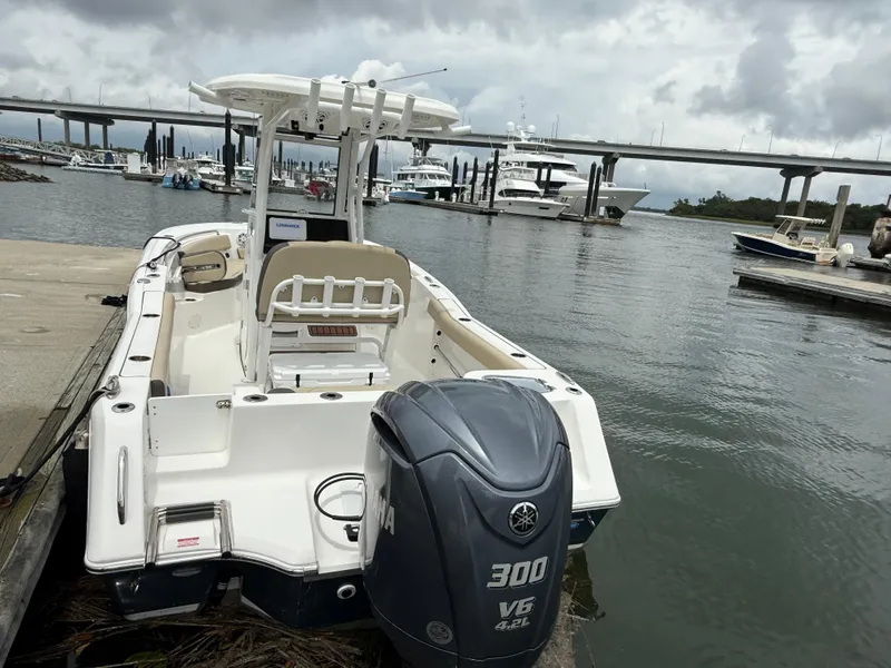 Slide: The Image of 2022 Tidewater 232 CC Adventure boat docked, featuring Yamaha 300 V6 engine, overcast sky. - 6