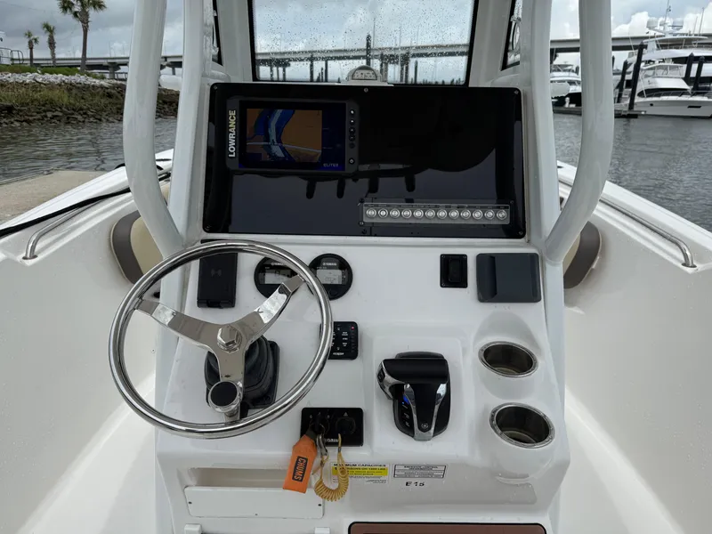 Slide: The Image of 2022 Tidewater 232 CC Adventure boat console with steering wheel and navigation system. - 7