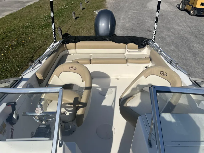 Slide: The Image of 2020 Key West 203DFS boat interior with beige seating and steering console. - 5