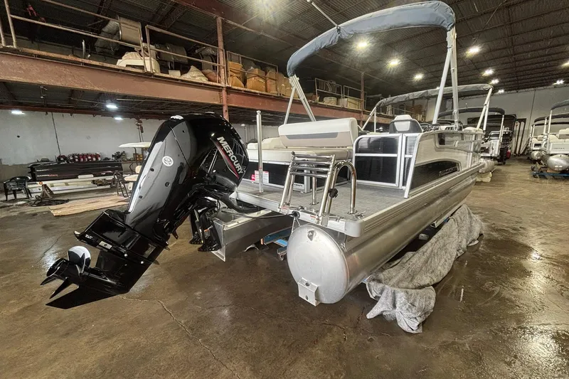 Slide: The Image of 2025 Princecraft Vectra 21 RL pontoon boat with Mercury outboard in a warehouse setting. - 12
