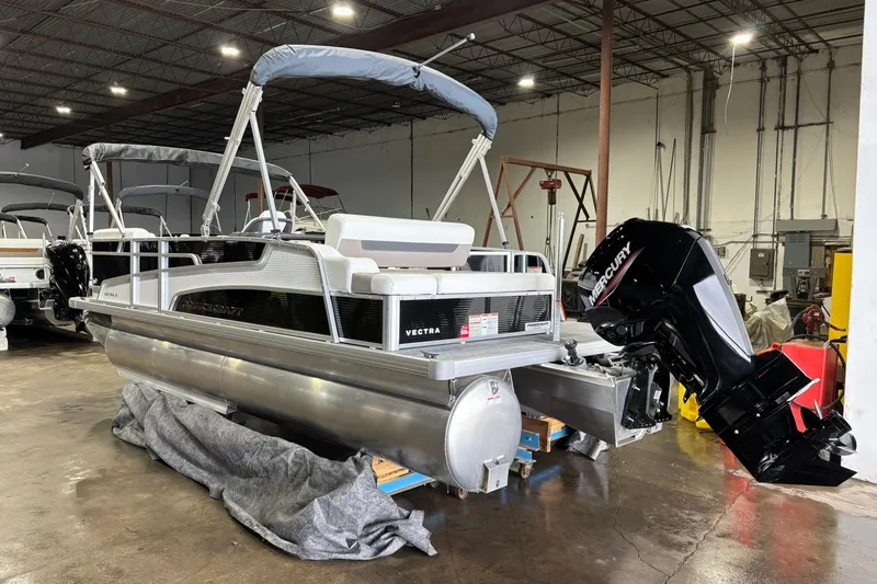 Slide: The Image of 2025 Princecraft Vectra 21 RL pontoon boat with Mercury outboard in a warehouse setting. - 13