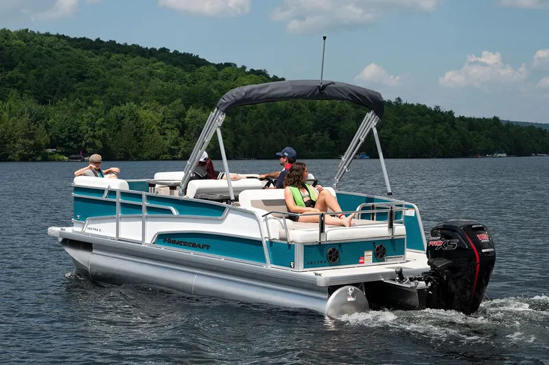 Slide: The Image of 2025 Princecraft Vectra 21 RL pontoon boat with Mercury outboard motor in a warehouse setting. - 3