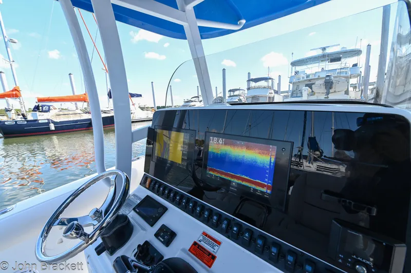 Slide: The Image of 2014 Sea Hunt Gamefish 30 dashboard with navigation display at marina. - 11