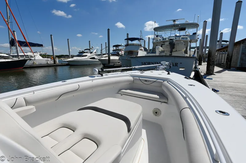 Slide: The Image of 2014 Sea Hunt Gamefish 30 boat docked at marina under clear blue sky. - 13