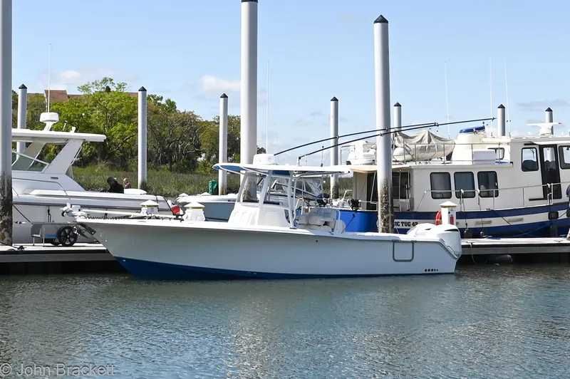 Slide: The Image of 2014 Sea Hunt Gamefish 30 boat docked at marina. - 2