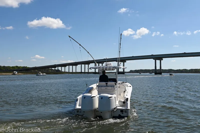 Slide: The Image of 2014 Sea Hunt Gamefish 30 boat cruising under a bridge on a sunny day. - 3
