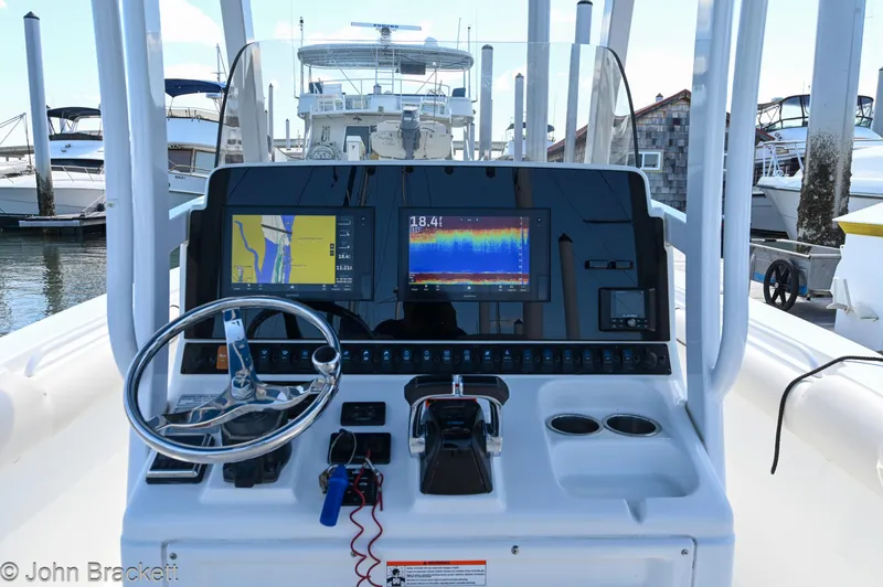 Slide: The Image of 2014 Sea Hunt Gamefish 30 boat dashboard with navigation and control systems at a marina. - 4