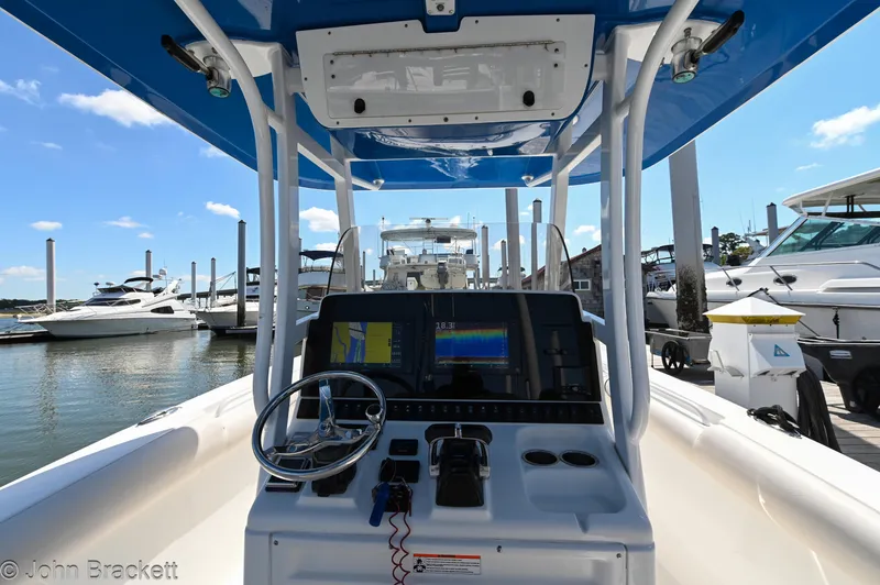 Slide: The Image of 2014 Sea Hunt Gamefish 30 boat dashboard with navigation equipment at marina. - 5