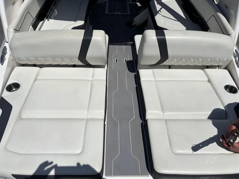 Slide: The Image of 2019 Regal 25 RX Surf boat interior with white cushioned seating and cup holders. - 10
