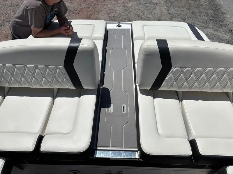 Slide: The Image of 2019 Regal 25 RX Surf boat interior with white cushioned seating and diamond stitching. - 12
