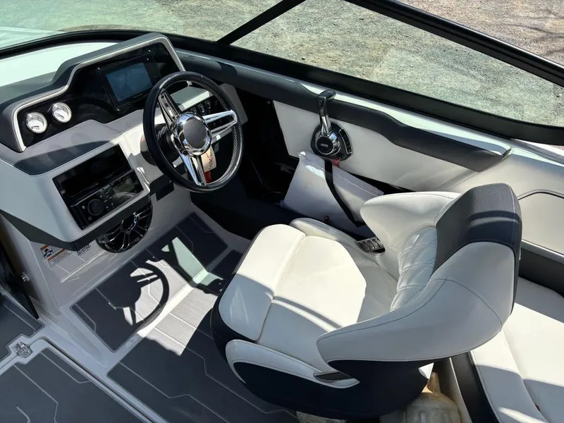 Slide: The Image of 2019 Regal 25 RX Surf boat interior with modern dashboard and comfortable seating. - 13