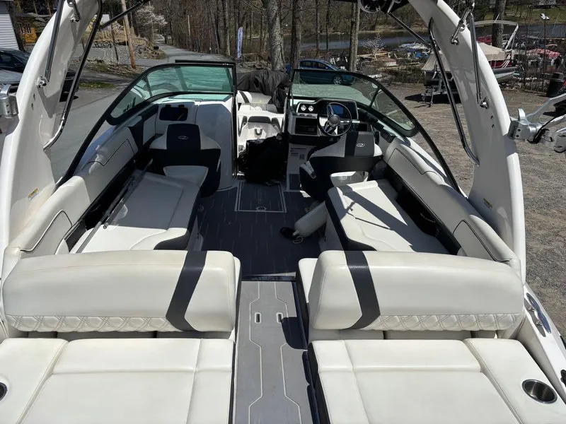 Slide: The Image of 2019 Regal 25 RX Surf boat interior with white seating and modern dashboard. - 15