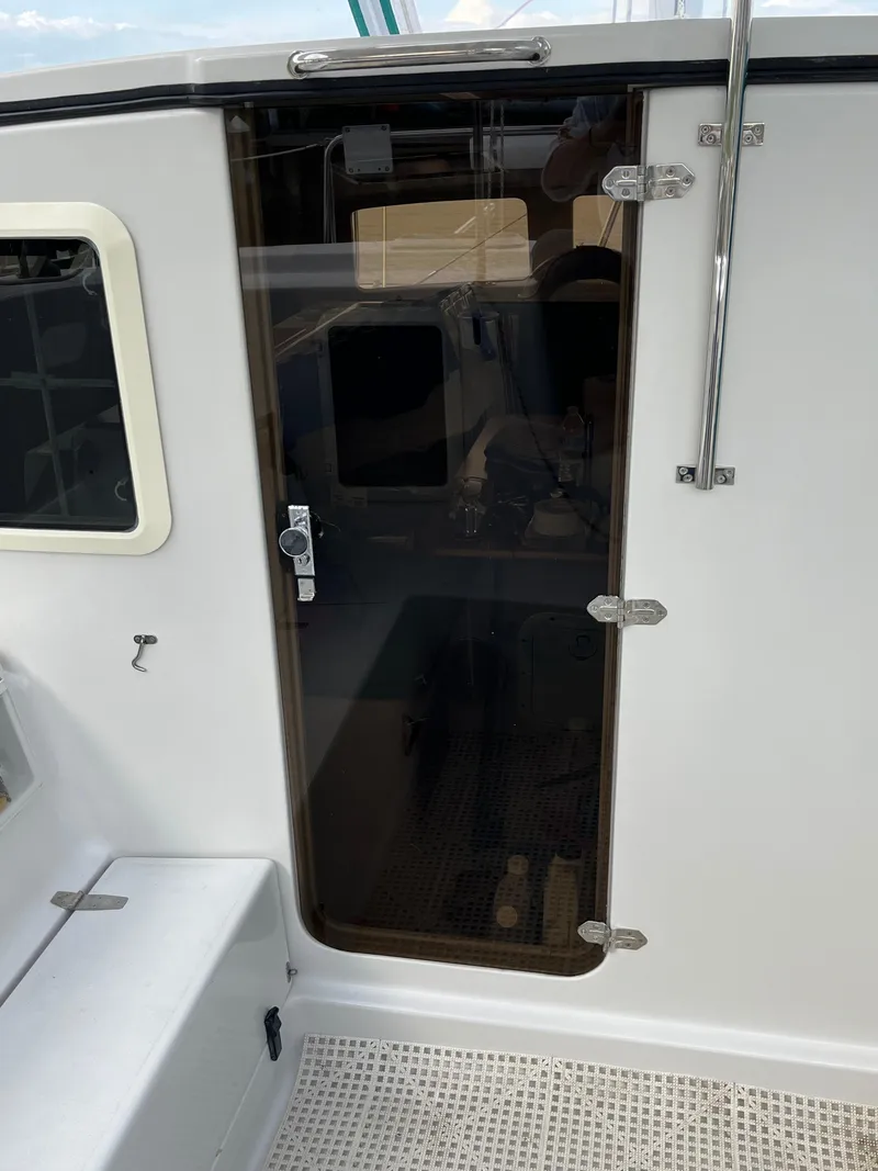 Slide: The Image of Glass door on a 2003 PDQ 32 boat, showing cabin entrance. - 12