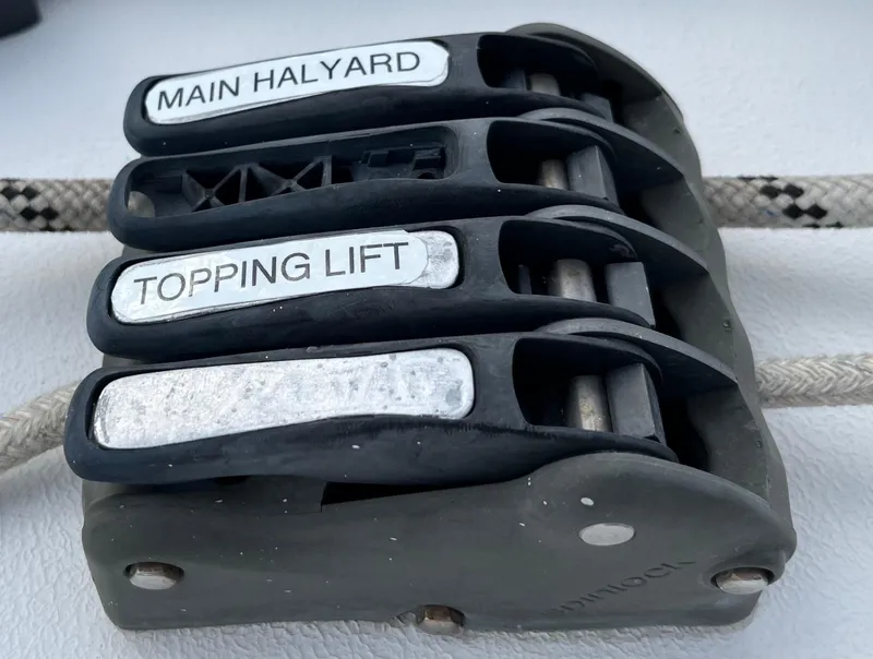 Slide: The Image of Sailing rope clutches labeled "Main Halyard" and "Topping Lift" on a PDQ 32, 2003 model. - 16