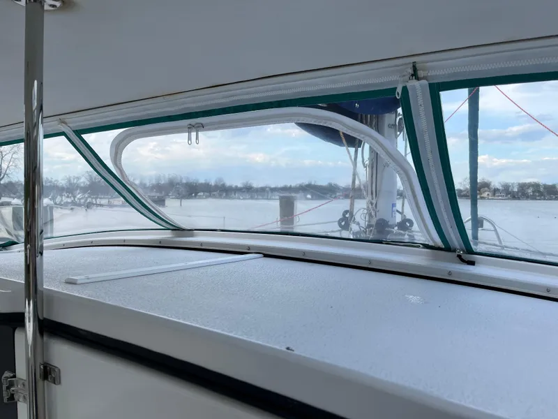 Slide: The Image of Interior view of a 2003 PDQ 32 boat with a scenic water backdrop. - 18