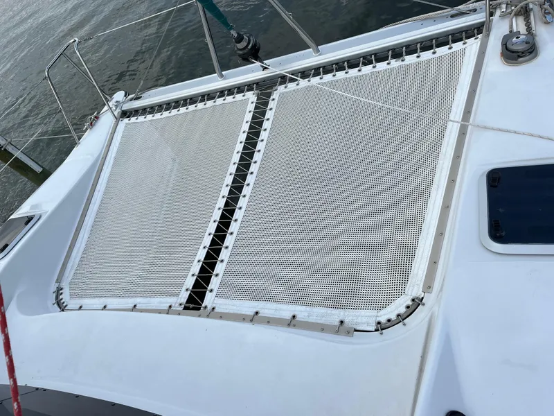 Slide: The Image of Catamaran deck with mesh netting, PDQ 32 model, 2003, on calm water. - 19