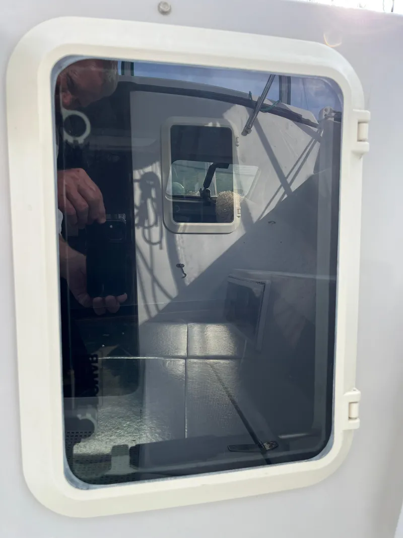 Slide: The Image of Window reflection on a 2003 PDQ 32 boat, showing interior and exterior details. - 24