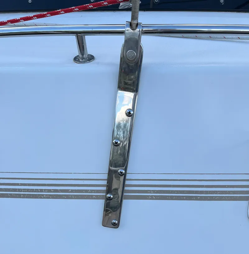 Slide: The Image of Stainless steel fitting on PDQ 32 boat, 2003 model, with red rope and striped design. - 26