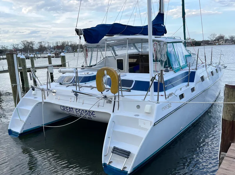 Slide: The Image of PDQ 32 catamaran docked, named "Great Escape," with blue accents, 2003 model. - 28