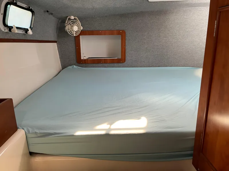 Slide: The Image of Cozy cabin interior of 2003 PDQ 32 with bed, window, and fan. - 35