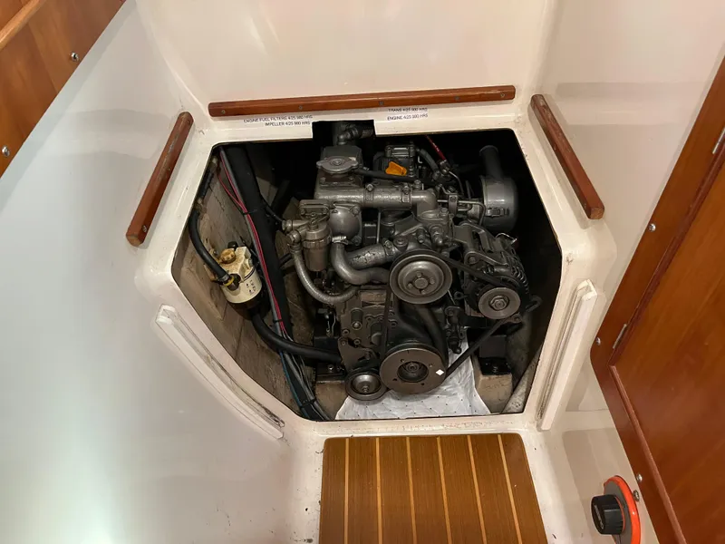 Slide: The Image of Engine compartment of a 2003 PDQ 32 boat, showcasing mechanical components and wiring. - 41