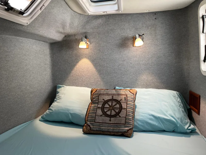 Slide: The Image of Cozy cabin interior of 2003 PDQ 32 with nautical-themed decor and soft lighting. - 42
