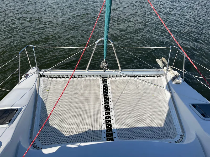 Slide: The Image of PDQ 32 catamaran deck with netting, 2003 model, on calm water. - 43